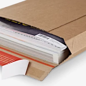 Stapel von Magazinen oder Heften, teilweise in einer offenen Versandtasche. Teil eines roten ColomPac®-Selbstklebeverschluss sichtbar.