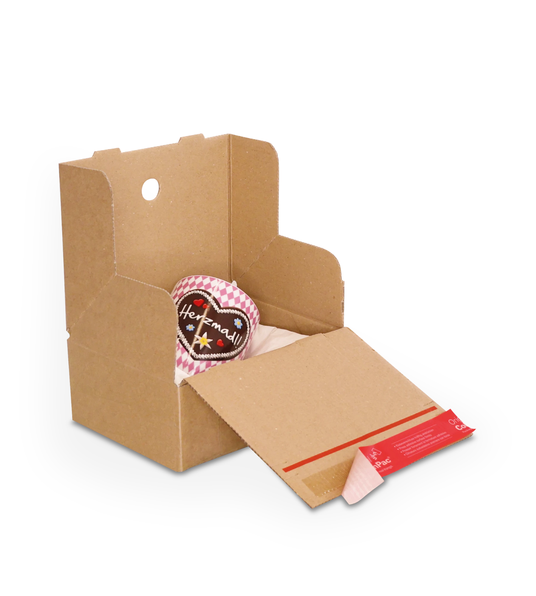 Geöffneter Versandkarton aus Wellpappe mit einer Tasse mit Herzmotiv im Inneren. Mit roten ColomPac-Selbstklebeverschluss unten.